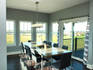 The dining area of a modern home with expansive windows